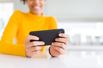 Close up of young african woman using smartphone