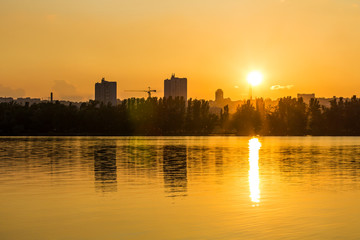 Fototapeta premium City at sunset near the water