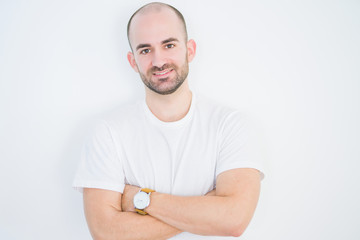 Young bald man over white isolated background happy face smiling with crossed arms looking at the...