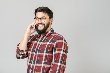 Cheerful happy young man laughing smiling talking on phone