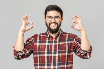 Portrait of handsome excited man smiling and showing ok sign