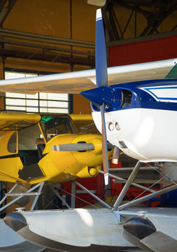 Close-up view of floatplanes (seaplanes) standing in hangar.