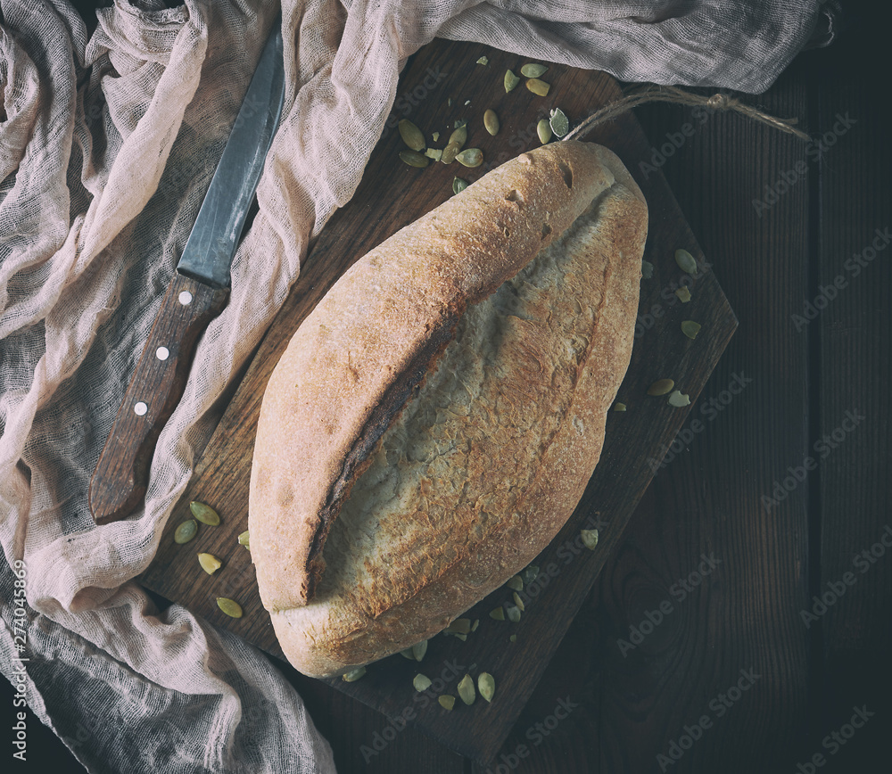 Wall mural baked crisp oval bread and vintage knife