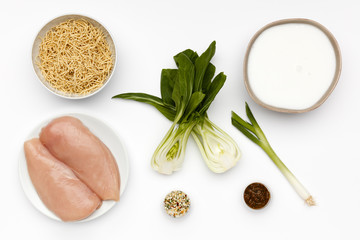 Fototapeta na wymiar Raw ingredients for a bowl of delicious Chicken Laska and noodles with vegetables and spice