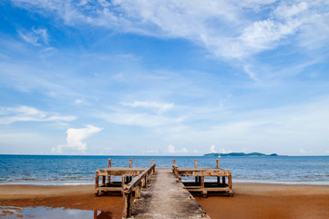 Grungy old concrete ship port pier bridge and tropical sea and beach