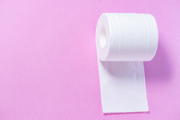 Eco-friendly white toilet paper on a pink background close-up