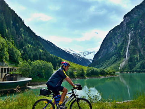 Austrian Alps-outlook of the cyclist and lake Stillupspeicher with waterfall © bikemp