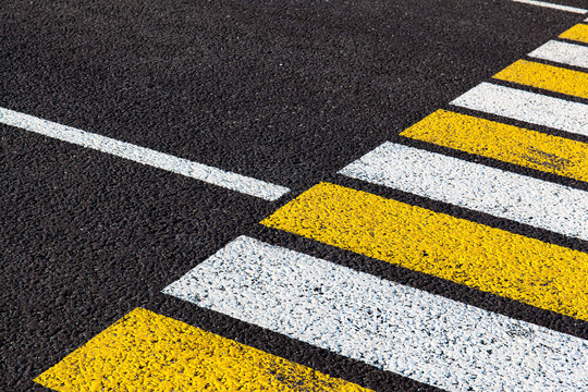 bright markings of a pedestrian crossing on asphalt, background, texture