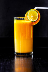 An orange juice with black background