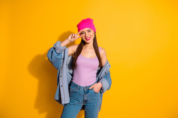 Portrait of attractive confident lovely teen teenager youth make v-signs have weekend feel she content candid model wear fashionable clothes isolated yellow vibrant background