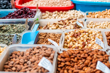 Nuts and dried fruits collection in the plastic boxes ready for sale on the marketplace in Belgrade. Close up