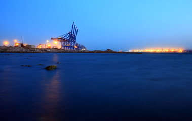 Fototapeta na wymiar Cranes at the cargo terminal in the evening
