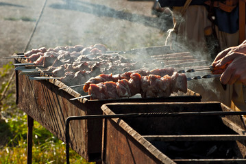 Slice pieces of meat on the grill. barbecue at the festival. Cheese and roasted veal on skewers.