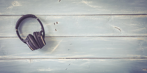 wireless headphones on vintage background