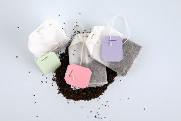 Teabags with spilled tea and label. Top view, on a white background. Mockup