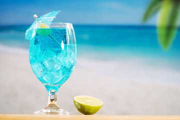 Glass of cooling blue drink and sliced lime
