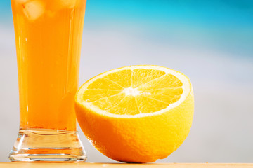 Ripe sliced orange and glass of juicy drink