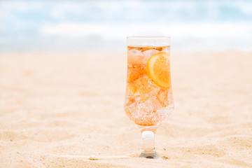 Glass of fresh orange drink with sliced citrus