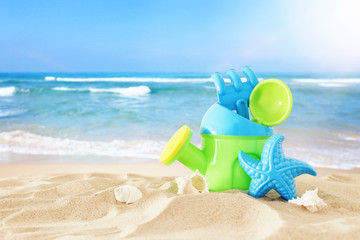 vacation and summer image with beach colorful toys for kid over the sand