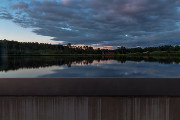 A cycling path through the water in Bokrijk Belgium during a sunset with a dramatic sky