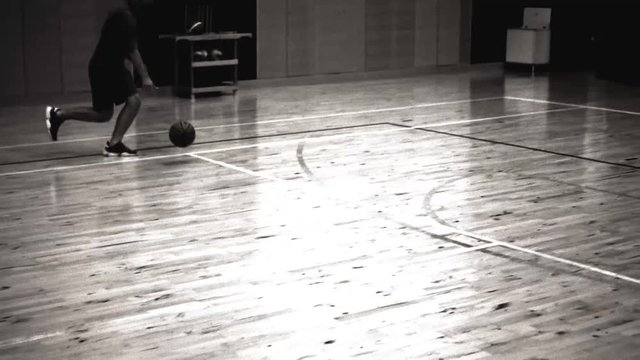 man plays basketball, old movie style