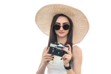 Portrait of young woman in hat with camera isolated on white