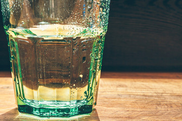 Glass of water on dark background close up