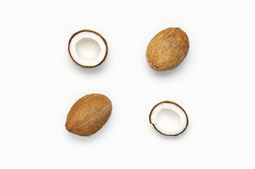 Fresh coconut on light gray background flat lay style Top View Copy Space. Pattern with ripe coconuts. Pop art design, creative summer and food concept. Tropical fruit whole half abstract background