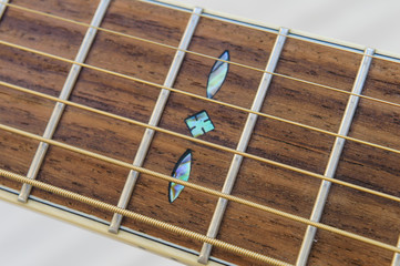 Acoustic Guitar detail - fretboard and inlay - above close