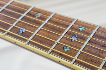Acoustic Guitar detail - fretboard and inlay - from side