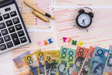 Australian dollars with calculator on tax declaration