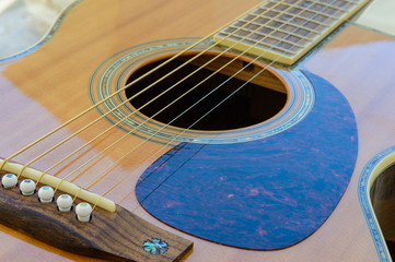 Obraz premium Acoustic Guitar detail - sound hole and scratch plate - from below