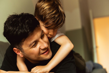 Smiling son playing with his father	