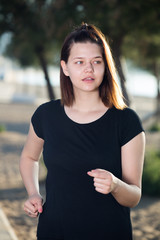Female 20-30 years old is jogging in black T-shirt
