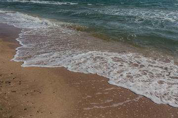 Soft wave of the sea on the sandy beach. Natural background