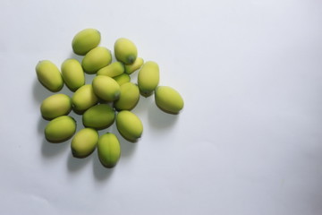 Lotus (Nelumbo nucifera) seeds against white background.Also known as sacred lotus, bean of India, Egyptian bean