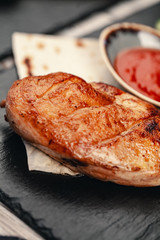 Marinated grilled healthy chicken breasts cooked on a summer BBQ