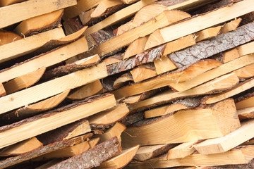 Wood for the village stove or fireplace stacked in a stack. Dry wood texture. Ecologically clean fuel. Selective focus.