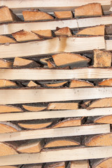 Wood for the village stove or fireplace stacked in a stack. Dry wood texture. Ecologically clean fuel. Selective focus.