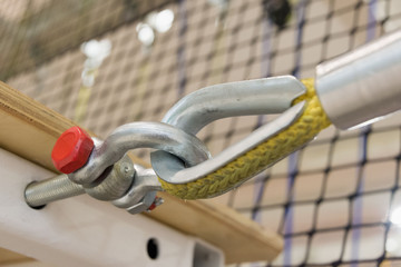 fastening a yellow nylon rope to a metal structure close-up. equipment in the obstacle course