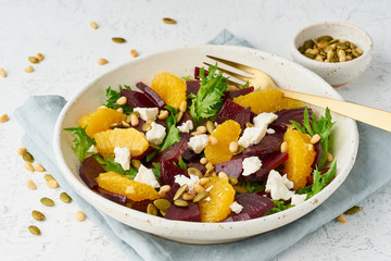 Vegan salad with beet curd avocado orange feta ricotta and pumpkin seeds, keto ketogenic dash diet, closeup, pastel modern background