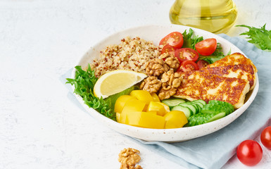 Buddha bowl with halloumi, salad lettuce, quinoa, vegetarian menu, white background, closeup with...