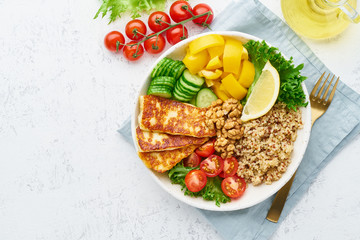 Buddha bowl with quinoa, halloumi, salad lettuce, vegeterian cuisine, white background, top view