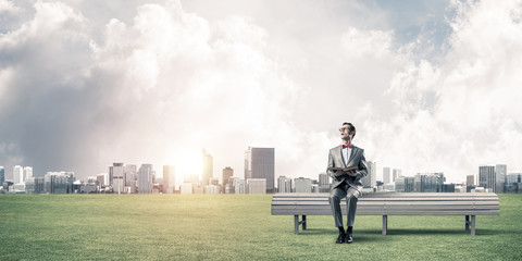 Young businessman or student studying the science and cityscape at background