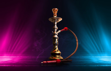 Hookah, smoke on a dark abstract background. Background of empty scenes with multicolored neon...