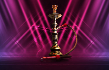 Hookah, smoke on a dark abstract background. Background of empty scenes with multicolored neon lights, reflection of night lights on wet pavement