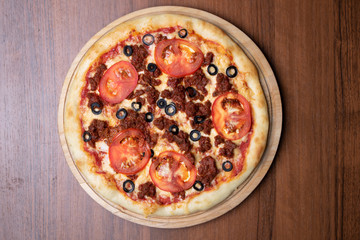 margarita pizza on brown table