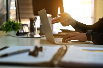 Cropped shot business analysis with laptop computer.