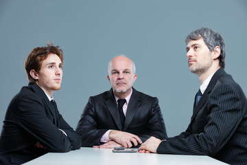Three bored businessmen in a meeting