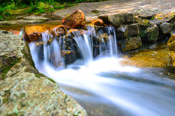 Naklejka na ściany i meble beautiful little waterfall at tropical forest